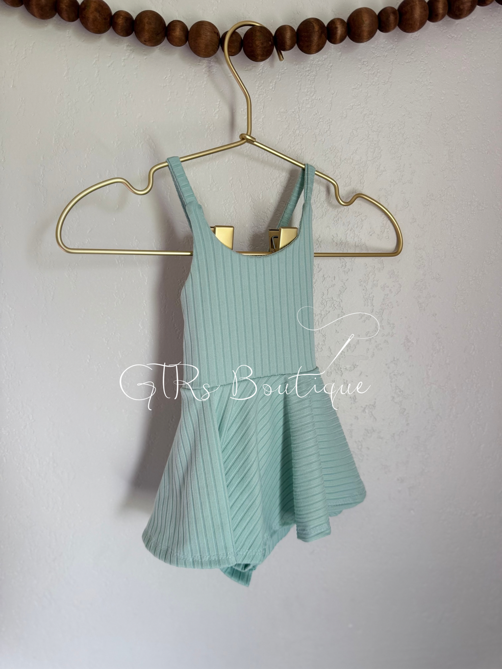 Baby skirted bodysuits with crissed crossed straps