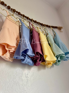 Baby skirted bodysuits with crissed crossed straps