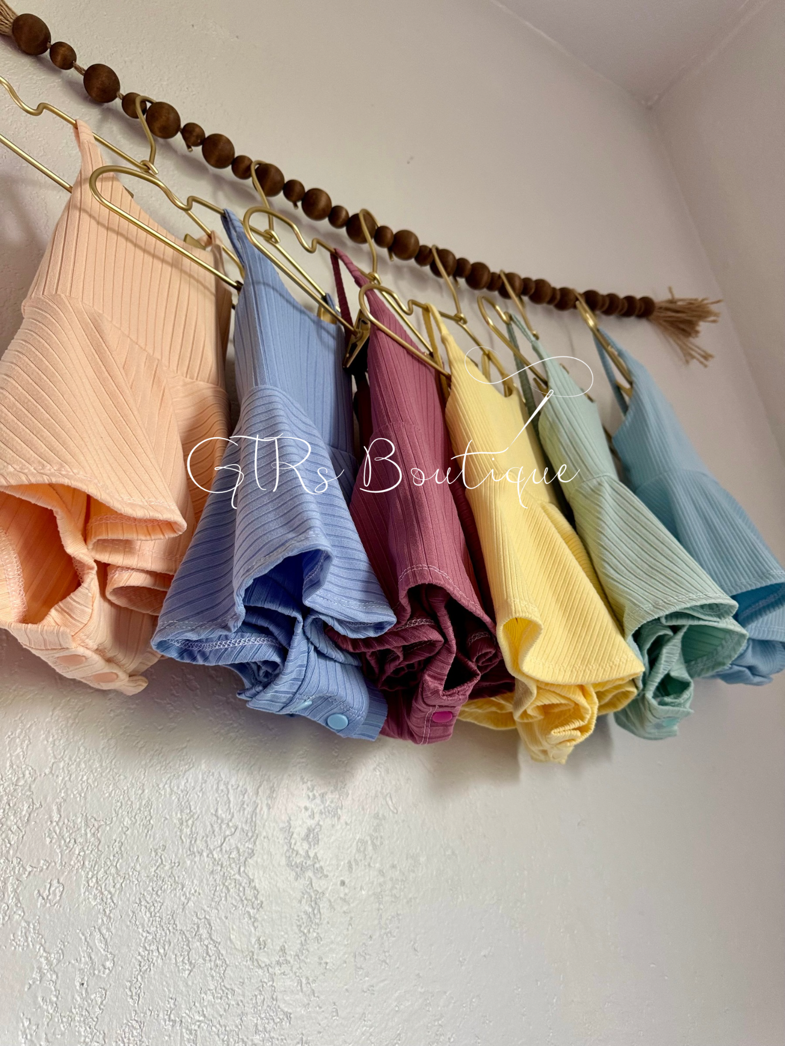 Baby skirted bodysuits with crissed crossed straps