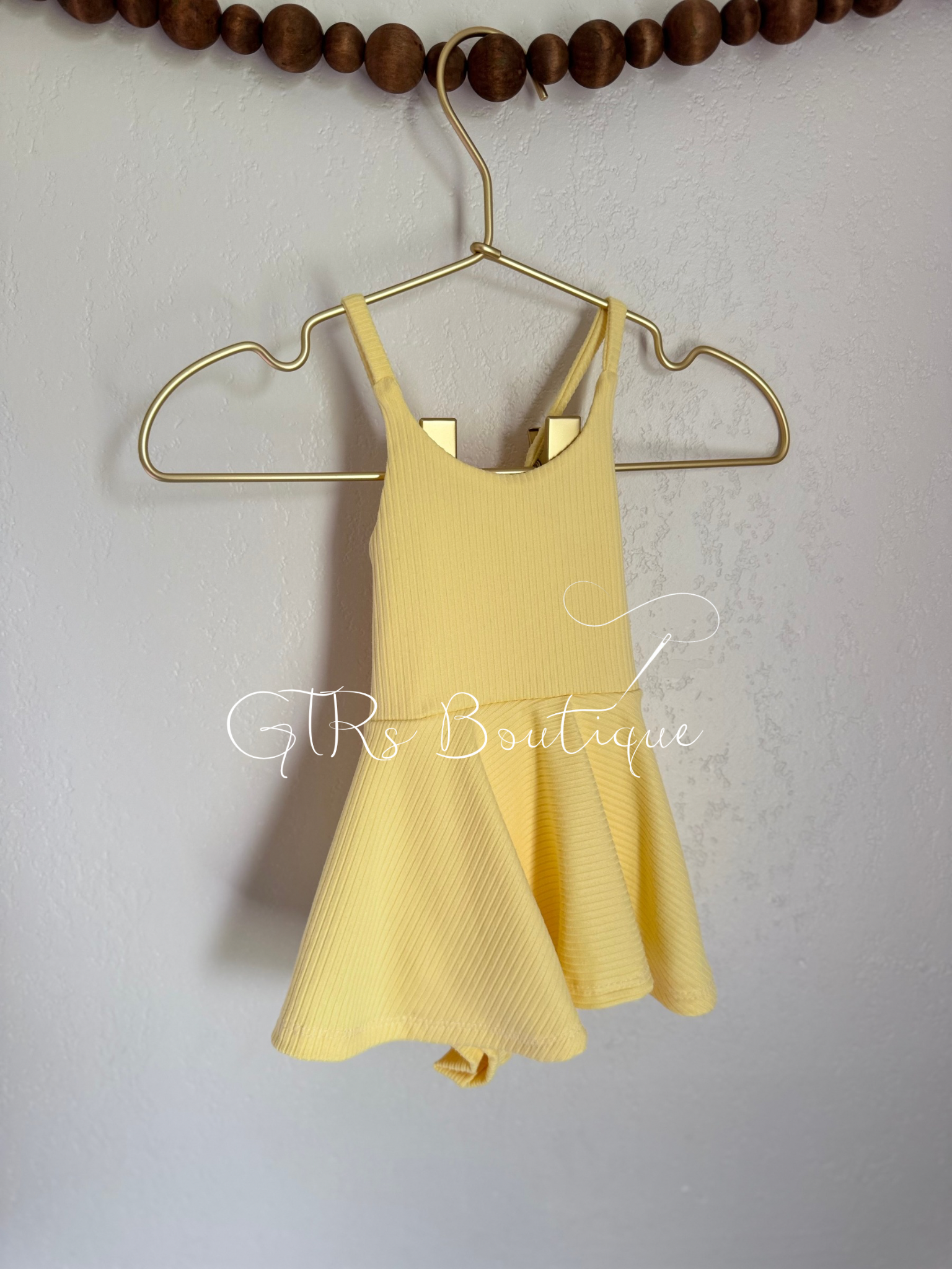 Baby skirted bodysuits with crissed crossed straps