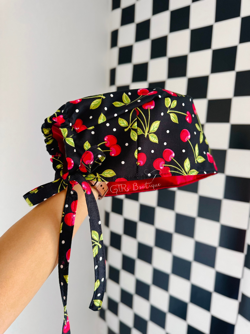 Red satin lining inside black cherry print tie back scrub cap