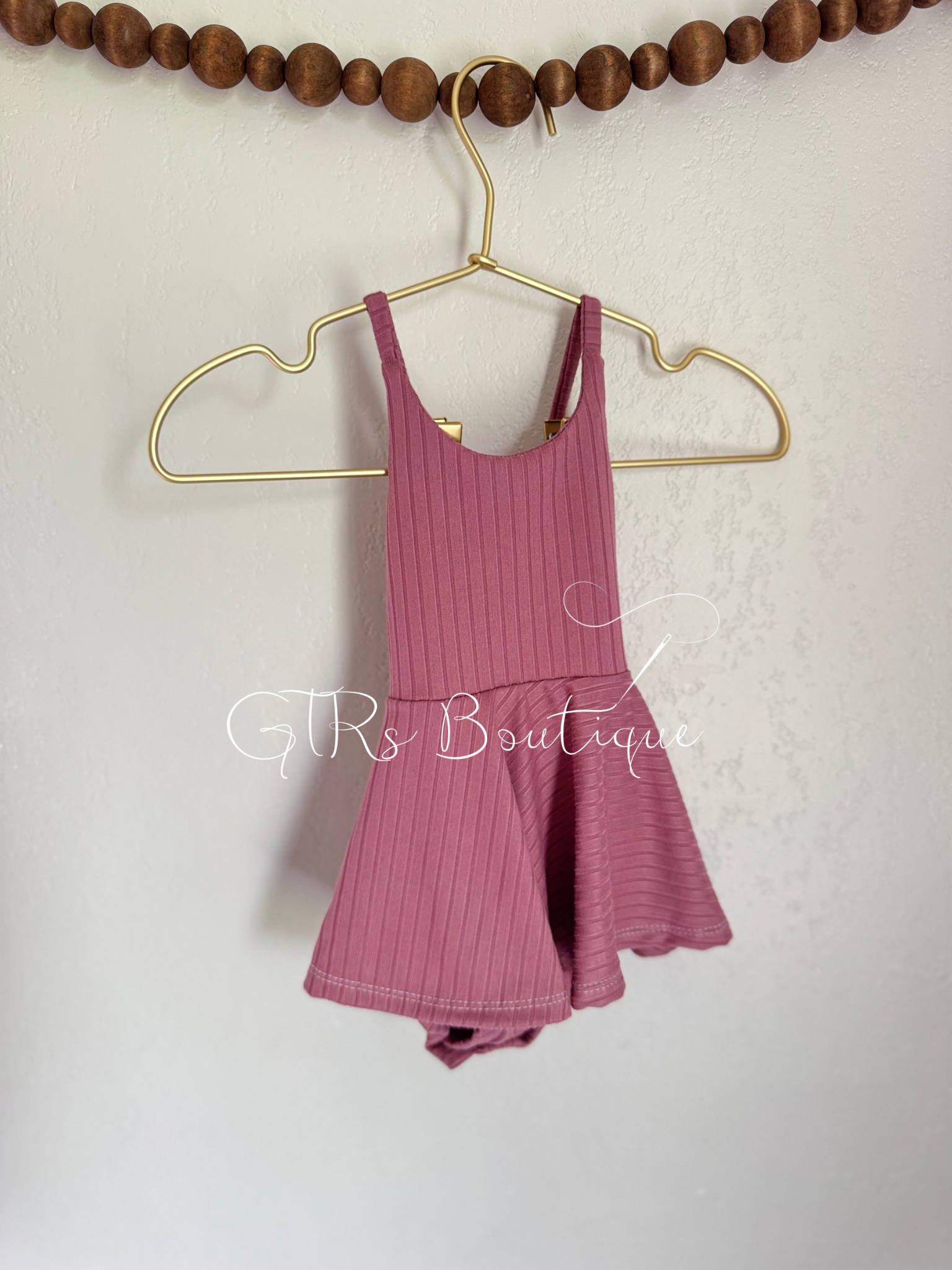 Baby skirted bodysuits with crissed crossed straps