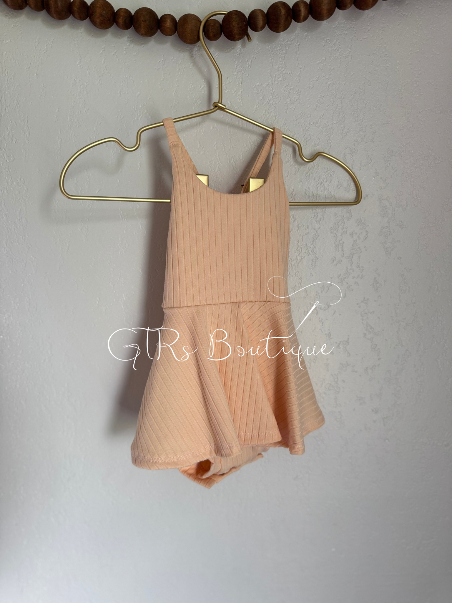 Baby skirted bodysuits with crissed crossed straps
