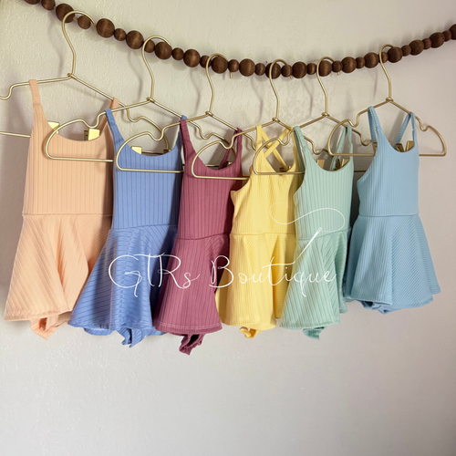Baby skirted bodysuits with crissed crossed straps