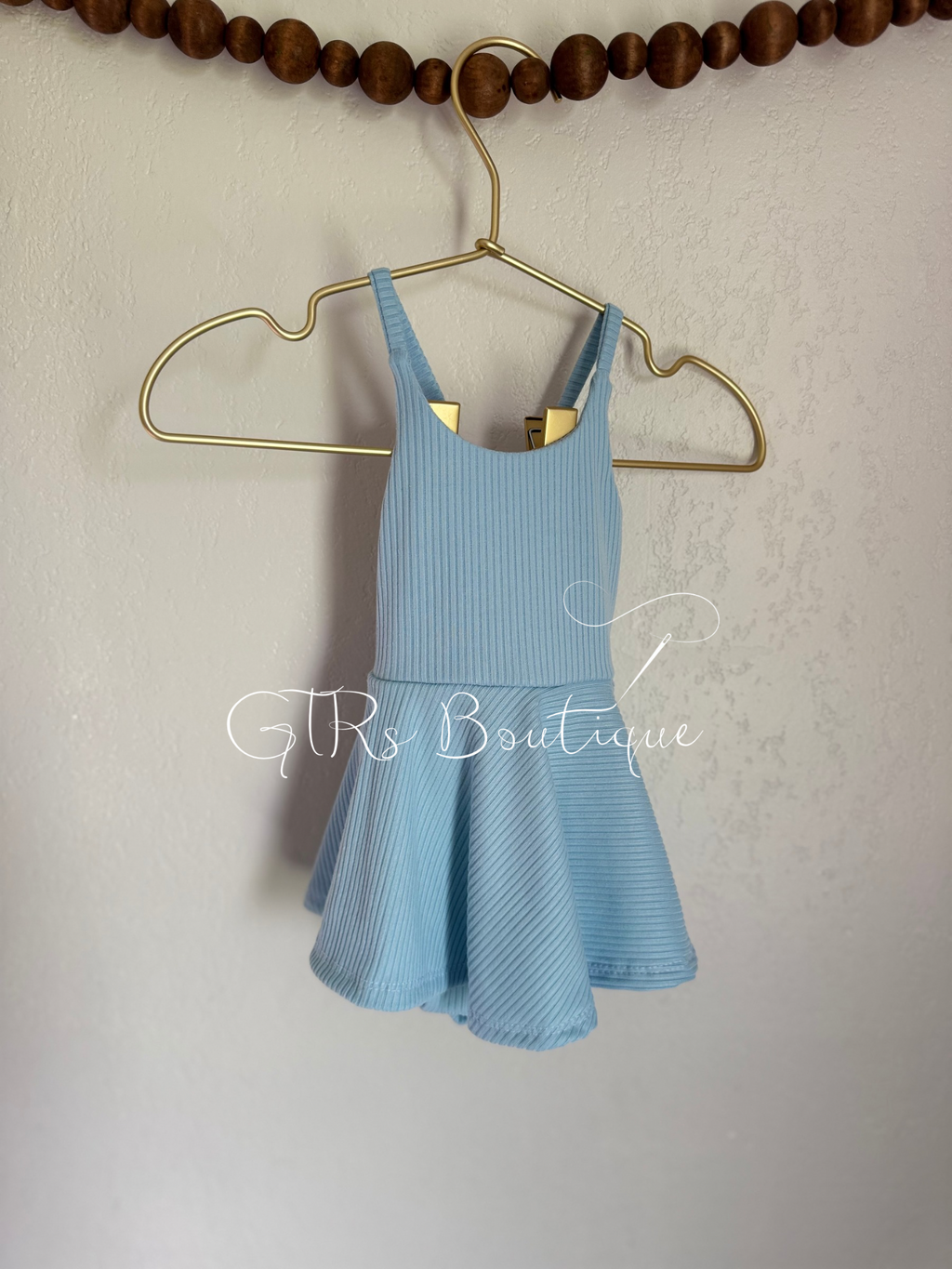 Baby skirted bodysuits with crissed crossed straps