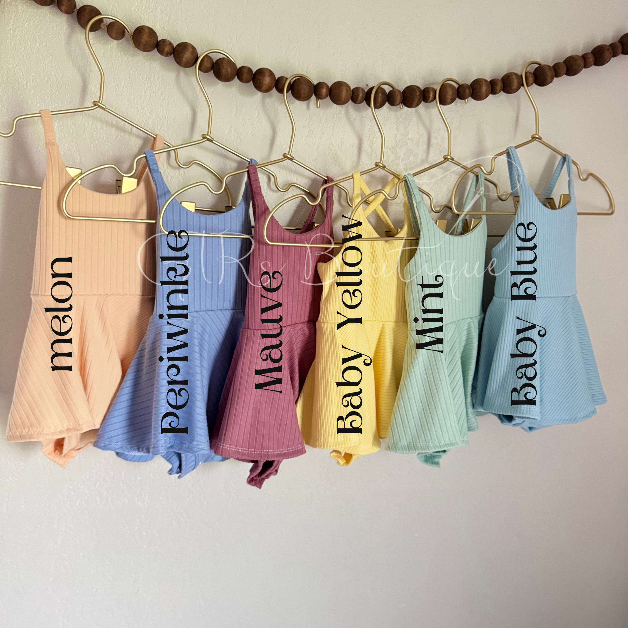Baby skirted bodysuits with crissed crossed straps