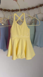 Baby skirted bodysuits with crissed crossed straps